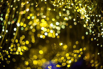 Fototapeta na wymiar Abstract blur gold sparkle bokeh background. Dark background Festive christmas background. Celebration party