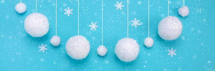 Fototapeta na wymiar Christmas composition. The concept of a winter festive background, snowfall from white balls on a blue background. Christmas, winter, new year concept. Banner Minimalism flat lay