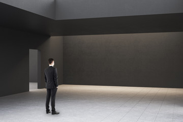 Fototapeta premium Businessman in modern gallery interior