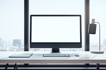 Designer desktop with empty black computer screen