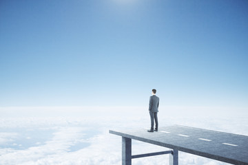 Businessman standing on end road