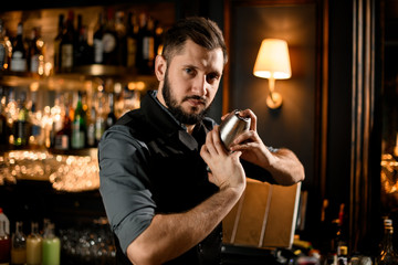 Portrait of a male bartender with shaker