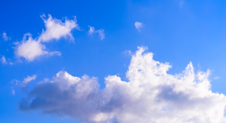 Dramatic puffy fluffy clouds isolated against blue skies