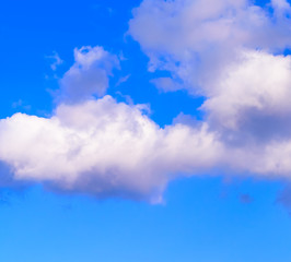 Dramatic puffy fluffy clouds isolated against blue skies