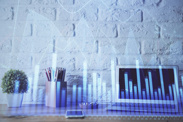 Financial graph colorful drawing and table with computer on background. Multi exposure. Concept of international markets.