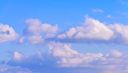 Dramatic puffy fluffy clouds isolated against blue skies