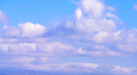 Dramatic puffy fluffy clouds isolated against blue skies