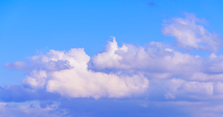 Dramatic puffy fluffy clouds isolated against blue skies