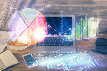 Double exposure of forex graph and work space with computer. Concept of international online trading.