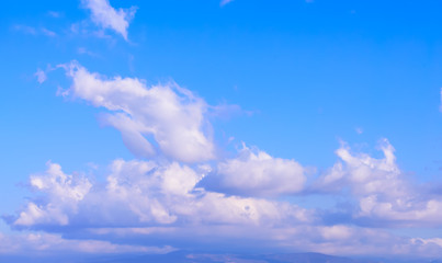 Dramatic puffy fluffy clouds isolated against blue skies