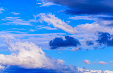 Dramatic puffy fluffy clouds isolated against blue skies