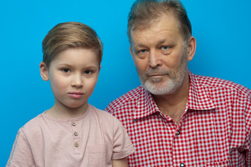 Portrait of cute positive grandfather and grandson