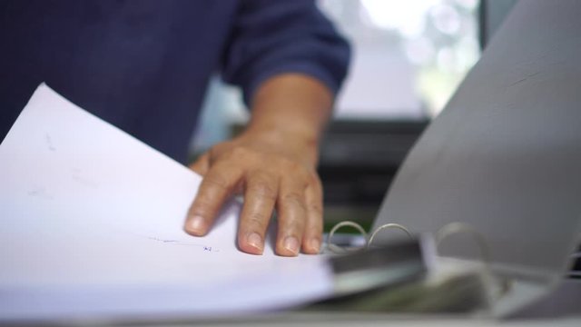 Businessman executive signing on official document paperwork files contract on office table for approval management of responsible, signature concept.