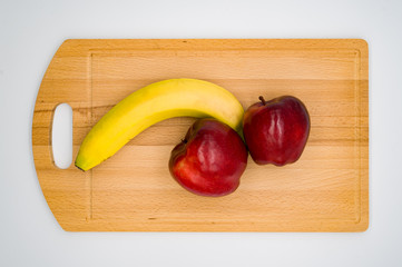 apple and bananas on wooden table