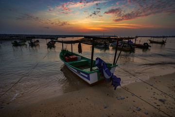 boat on beach at sunrise