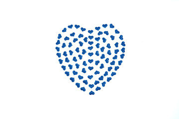 One blue big heart made up of many little hearts inside on white background