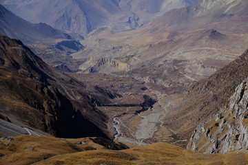 Harsh desert mountain scenery of Mustang land during the route from Thorung La to Muktinath, Himalaya, Nepal. During trekking around Annapurna, Annapurna Circuit.