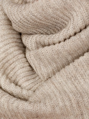Fototapeta na wymiar Knitted fabric natural beige wool cozy texture