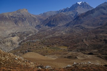 The dry mountain landscape of the amazing land of Mustang in the Himalaya in Nepal. Around Lupra. During Annapurna Circuit trekking.