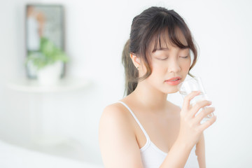 Beautiful portrait young asian woman caucasian smiling with nutrition thirsty and drinking glass of water mineral with fresh and happy, asia girl diet for healthy care and wellness, lifestyle concept.