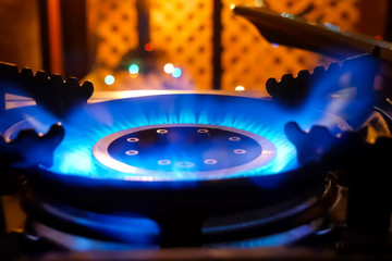 Burning gas stove. Blue flame of gas burner.