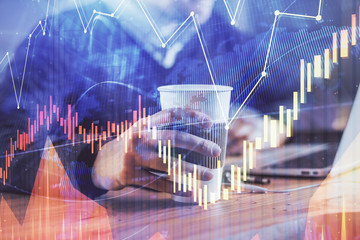 Forex graph with businessman working on computer in office on background. Concept of hardworking. Closeup. Multi exposure.