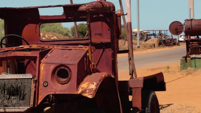 old rusty tow truck next to a old rusty steam locomotive in the middle of the desert