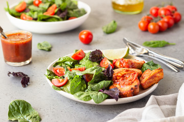 Roast chicken or turkey fillet with salad. Hot escalope of turkey or chicken with red sauce and salad. Healthy balanced eating.