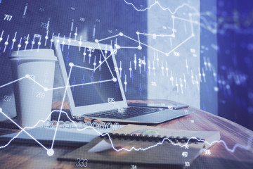 Forex market chart hologram and personal computer background. Multi exposure. Concept of investment.