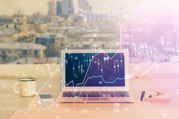 Financial graph colorful drawing and table with computer on background. Multi exposure. Concept of...