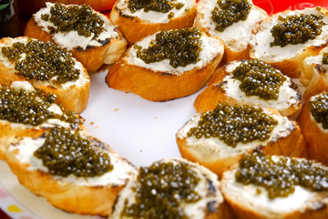Sandwiches from loaf with black caviar. Dear black caviar.