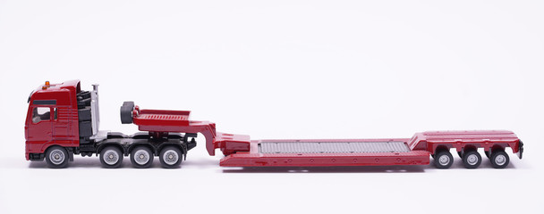 Red long car carrier. car transporter for transportation of other cars. Toy model miniature
