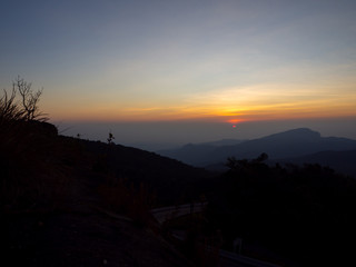 dramatic sunset over cloudy sky.