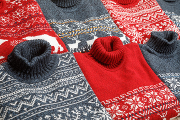 Collection of knitted Christmas turtleneck sweaters laid folded
