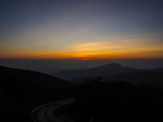dramatic sunset over cloudy sky.