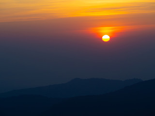 dramatic sunset over cloudy sky.