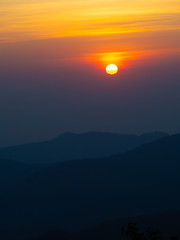 dramatic sunset over cloudy sky.