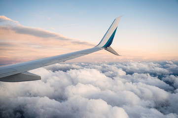 Obraz premium View of wing airplane on cloudy in the sky
