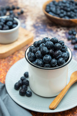 Ripe blueberries in metalic cup. Fresh berries for breakfast. Copy space.