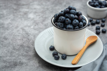 Ripe blueberries in metalic cup. Fresh berries for breakfast. Copy space.