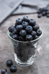 Blueberries in glass cup, selective focus. Blueberries isolated.