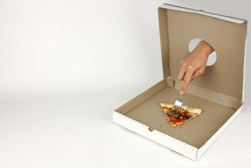 hand through hole in fastfood cardboard box impales on fork the last slice of vegetarian pizza,...