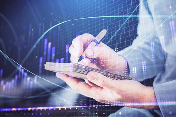 Double exposure hands with stock market chart.