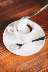 Cup of coffee espresso for lefties  with  milk froth on wooden background