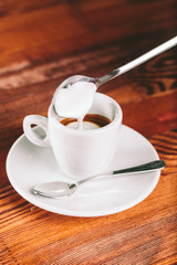 Cup of coffee espresso for lefties  with  milk froth on wooden background