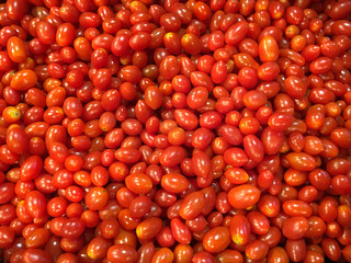 Fresh red cherry tomatoes in supermarket.Fresh cherry tomatoes background texture.