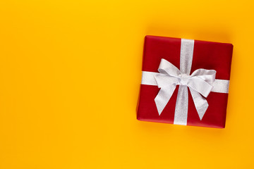 Christmas, holiday present box on red background.