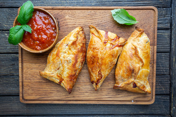Asian food Samsa or samosas with chicken fillet on cutting board. Top view