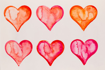 Watercolor painted pink heart, on the white watercolor paper.