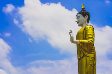 Obraz premium Buddha statue, Big standing Buddha statue at Wat Phra That Doi Kham in Chiang Mai, Thailand